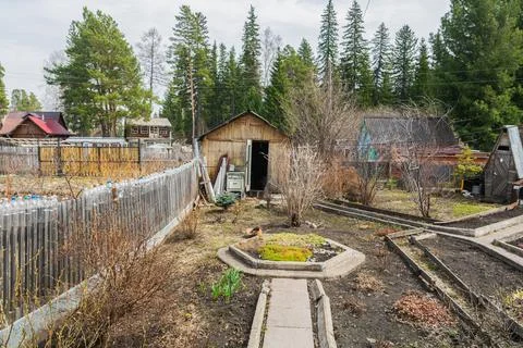 Spring garden with wooden structures in the spring in the forest. There are b Stock Photos