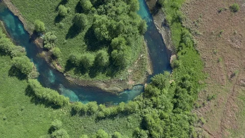 Spring green trees along the u-bend of a turquoise river Stock Footage 120697047