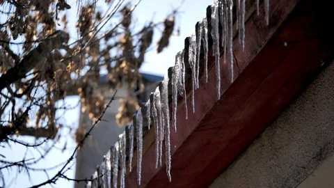 Spring has come. It has become warmer, icicles on the roof are melting Stock Footage 124465199
