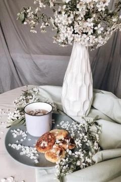 Spring healthy Breakfast fried cheesecakes, against a blooming bouquet flower Stock Photos