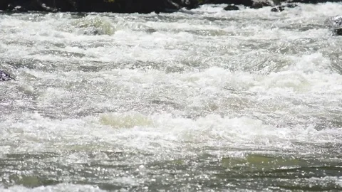 Spring high water flows in the mountain river Ursul. Rocks and water rapids Stock Footage 76353385