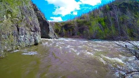 Spring high water flows in the mountain river Ursul. Rocks and water rapids Stock Footage 83234147
