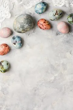Spring holiday Easter concept. Multicolored painted eggs on a concrete light Stock Photos