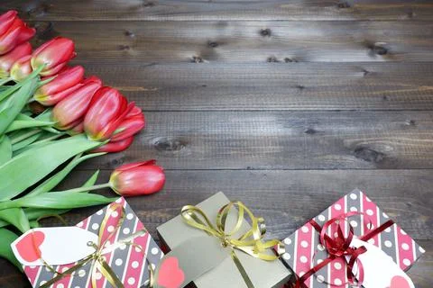 Spring holidays composition from gift boxes with labels, bows and ribbons Stock Photos