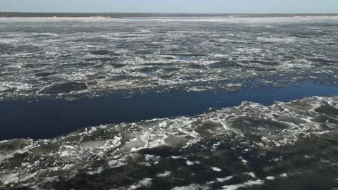 In the spring, ice floes float down the river. Ice drift is the movement of ice Stock Footage 152993721