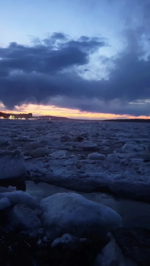 Spring Ice Run on River with City Lights and Sunset in Northeast China Stock Footage 337331026