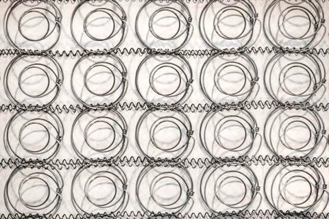 Spring inside the mattress. Box-spring texture. Stock Photos