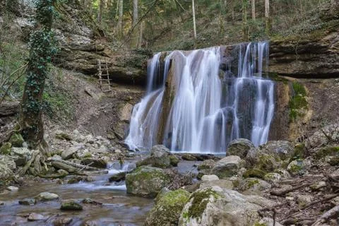 Spring Kaverinsky a Large waterfall flows down from the stone ledge in the go Stock Photos