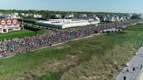 THE SPRING LAKE FIVE MILE RUN - THOUSANDS HEAD OUT TO TEST THEIR FITNESS. Video stock 242303935