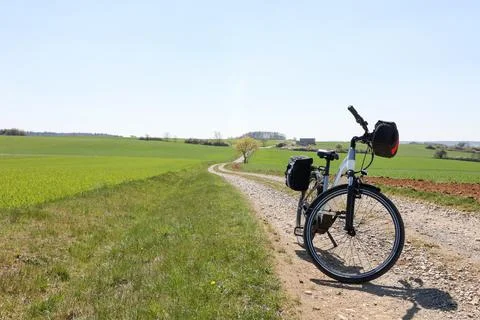 Spring landscape with an e-bike on the way Stock Photos