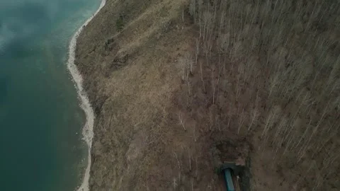 A spring landscape of Lake Baikal with a view of clearwater and a railway Stock Footage 311851260