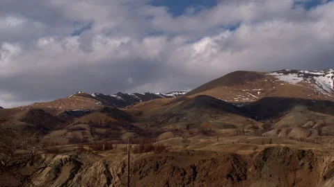 Spring landscape of mountains covered with snow. Timelapse of a mountain Stock Footage 241301331
