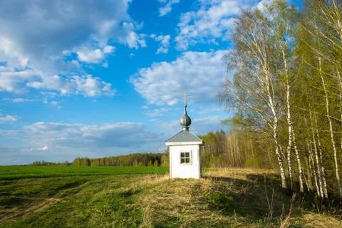 Spring landscape with a small chapel. Stock Photos