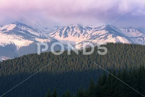 Spring landscape with snow peaks in the mountains Stock Photos