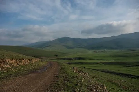 Spring landscape in sunset with clouds, hills and meadow. Zlatibor mountain a Stock Photos