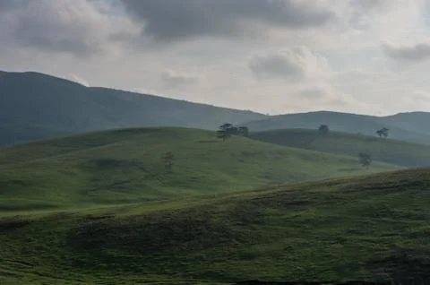 Spring landscape in sunset with clouds, hills and meadow. Zlatibor mountain a Stock Photos