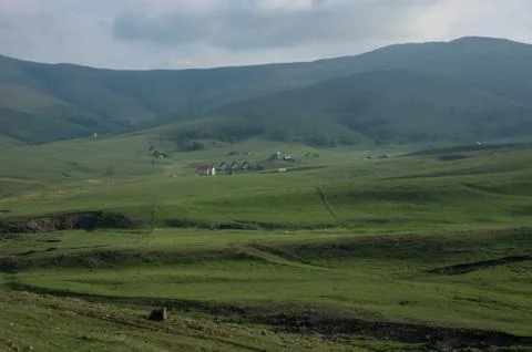 Spring landscape in sunset with clouds, hills and meadow. Zlatibor mountain a Stock Photos