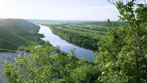 Spring landscape. Top view of river surrounded by a green forest and meadow. 4K 库存影片 92797050