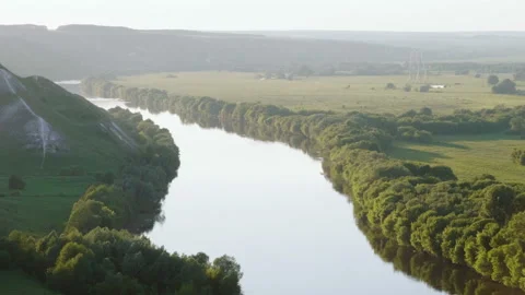Spring landscape. Top view of river surrounded by a green forest and meadow. 4K 库存影片 92797658