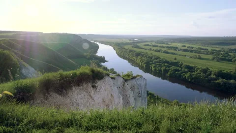 Spring landscape. Top view of river surrounded by a green forest and meadow. 4K Stock Footage 92797660