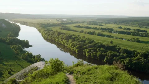 Spring landscape. Top view of river surrounded by a green forest and meadow. 4K Vidéo 93261278