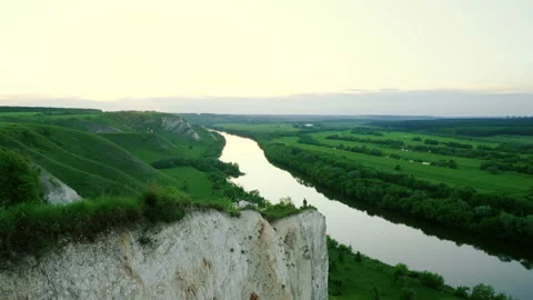 Spring landscape. Top view of river surrounded by a green forest and meadow. 4K Stock Footage 93261516