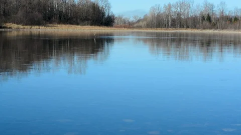 Spring landscape view of the river and mountains against the sky and houses Stock Footage 102480929