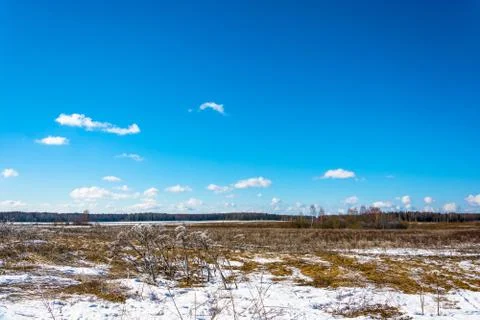 Spring landscape with white clouds on a blue sky. Stock Photos