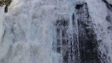 SPRING MELTED RUNOFF WATER TRICKLES DOWN AN ICEY CLIFF Stock Footage 84157567