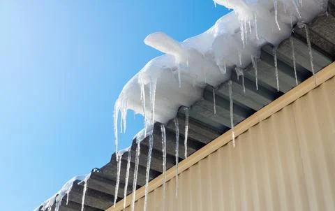 Spring melting of icicles on the building. Stock Photos