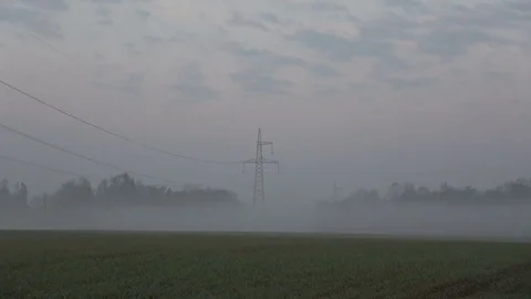 Spring mist in farmland with electrical tower against sunrise, 4K Video stock 74214300