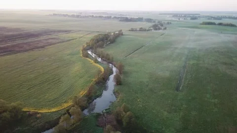 Spring morning landscape. Calm river in blooming meadows. Stock Footage 242527792
