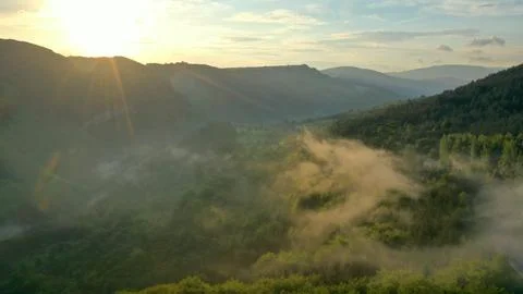 Spring mountain landscape with fogs in sunset light Stock Photos