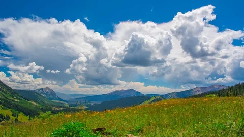 Spring Mountain Meadow overlooking the massive mountain ranges Time Lapse 4K Stock Footage 129357224