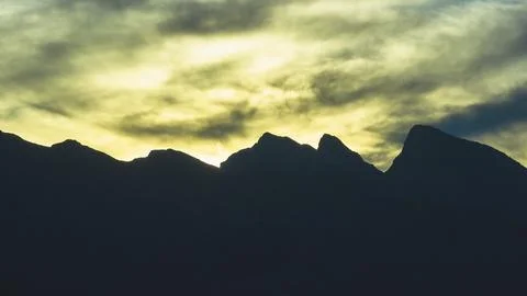 Spring Mountain Silhouette at Sunrise with Dramatic Sky and Cloud Patterns Stock Photos