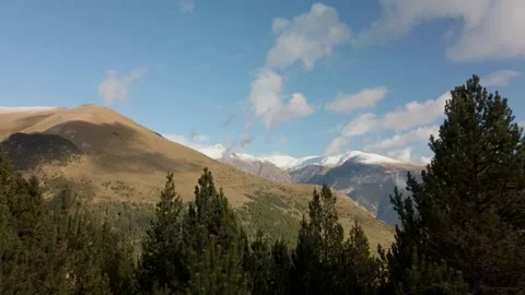 Spring mountain view with blue sky, clouds and trees Video stock 180989258