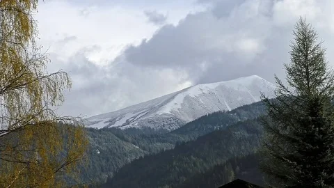 Spring in the mountains- Grass in the valleys and snow on the peaks Stock Footage 79698449