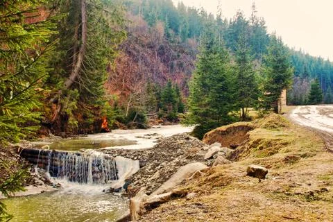 Spring Mountains river with river dam and stones hill. Stock Photos