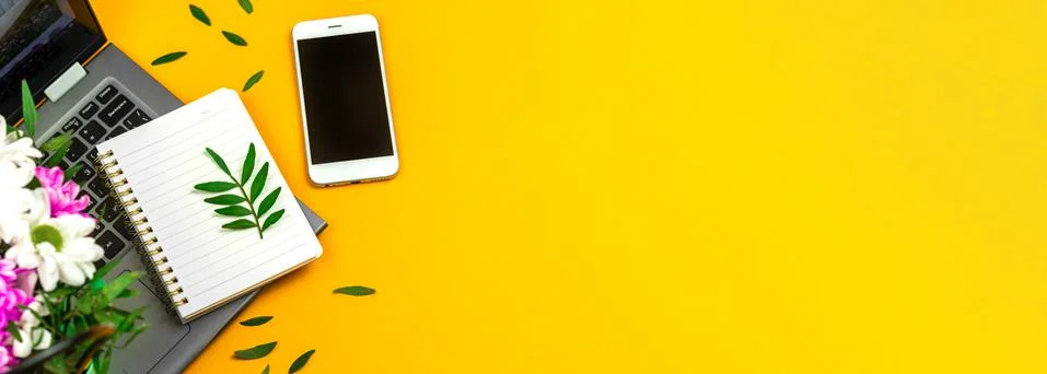 Spring office desktop or table with yellow background and bouquet of flowers, Stock Photos