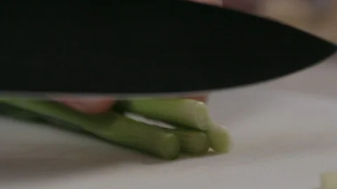Spring onion cut in slow motion Stock Footage 116898019