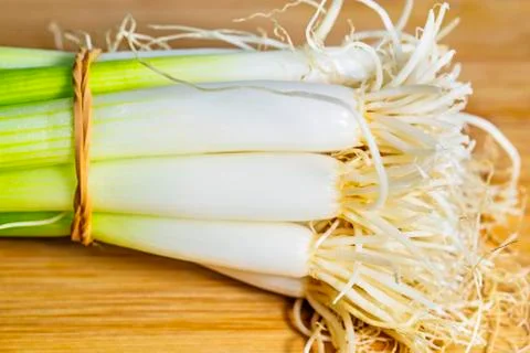 Spring onion on a plank Stock Photos