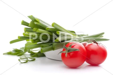 Spring onions and cherry tomato in bowl Stock Photos