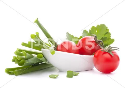 Spring onions and cherry tomato in bowl Stock Photos