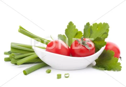 Spring onions and cherry tomato in bowl Stock Photos