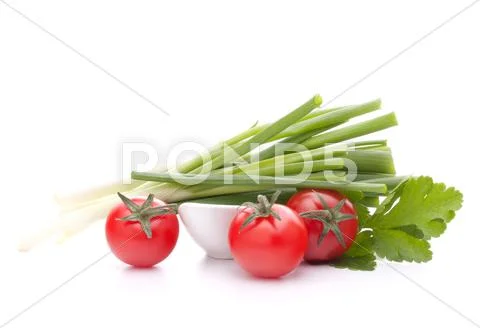Spring onions and cherry tomato in bowl Stock Photos