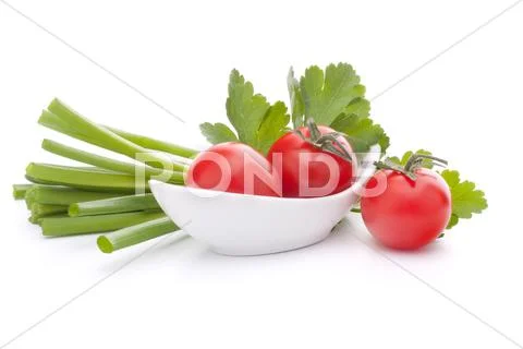 Spring onions and cherry tomato in bowl Stock Photos