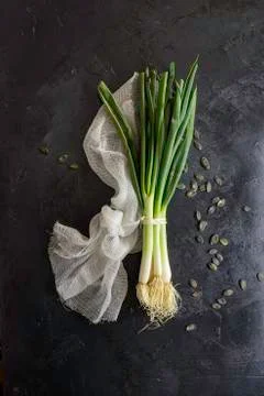 Spring onions close-up on dark table background Foto stock