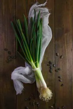 Spring onions close-up on dark table background 写真素材