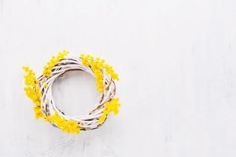 Spring or Easter background. Easter wreath decorated with mimosa flowers on Stock Photos