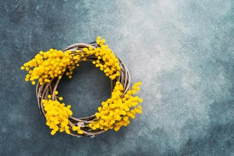 Spring or Easter background. Easter wreath decorated with mimosa flowers. Top Stock Photos